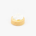 A Custard Cream Mini Dessert Tart on light grey background