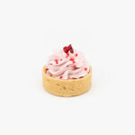 A Raspberry Mousse Mini Dessert Tart on light grey background