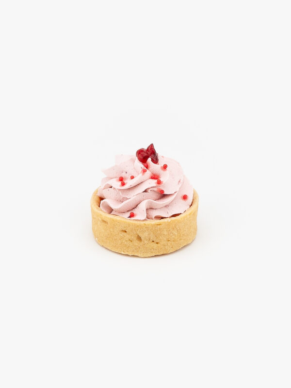 A Raspberry Mousse Mini Dessert Tart on light grey background