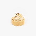 A Dulce De Leche Mini Dessert Tart on light grey background