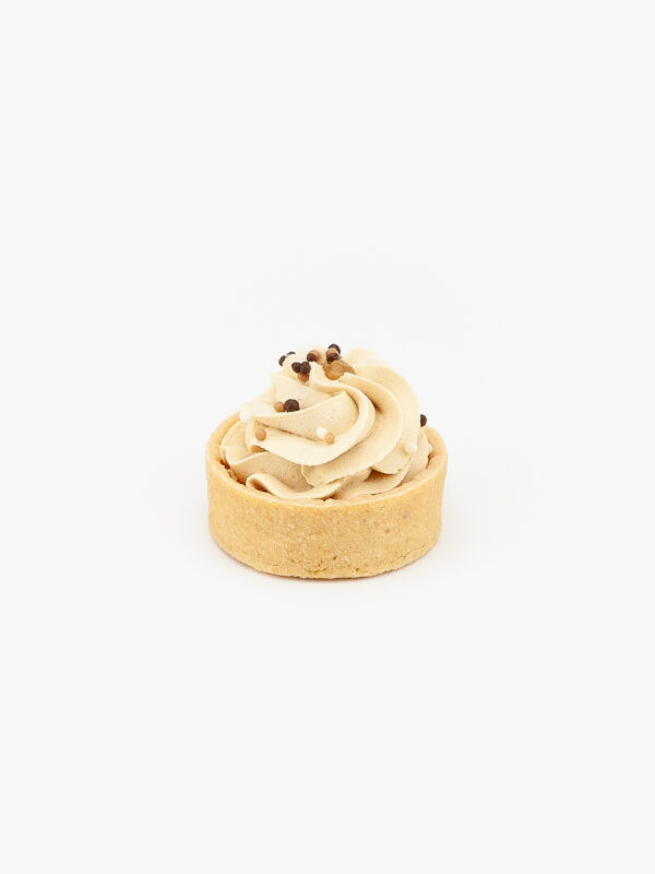 A Dulce De Leche Mini Dessert Tart on light grey background