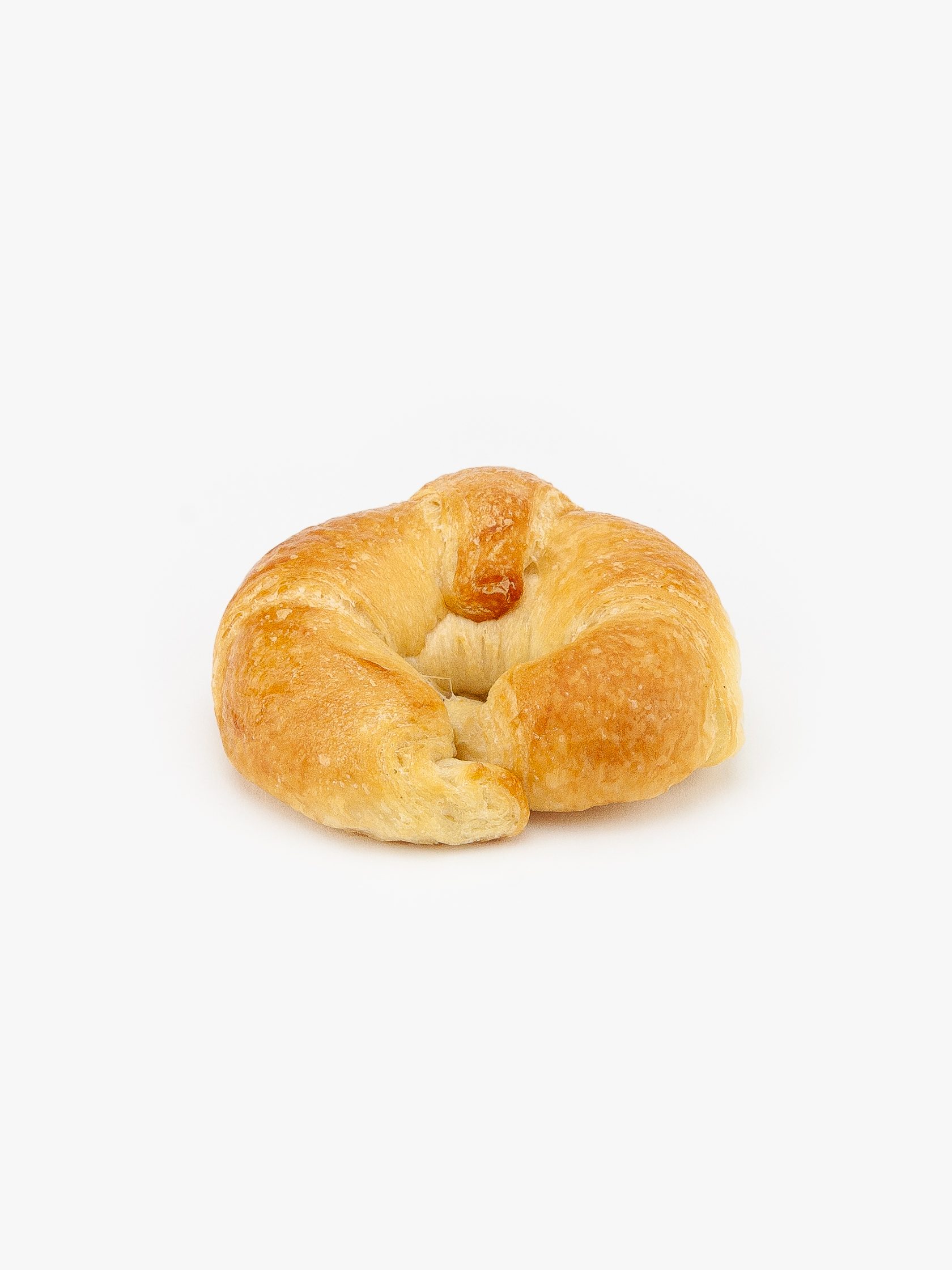 A Plain Vegan Regular Croissant no cut on a light grey background