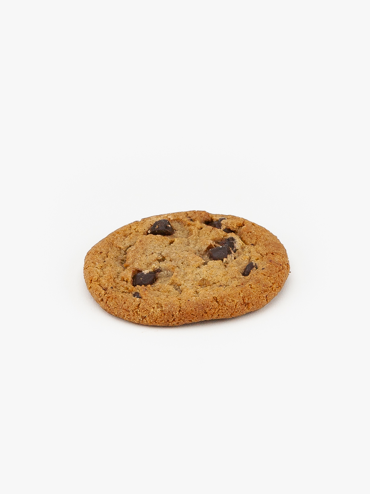 A single Vegan Regular Chocolate Chip Cookie on a light grey background