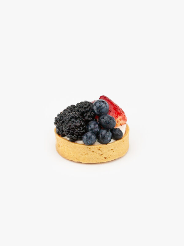 A Fresh Berry Individual Dessert Tart on a light grey background.